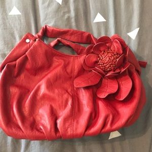 Red faux leather handbag with flower detail